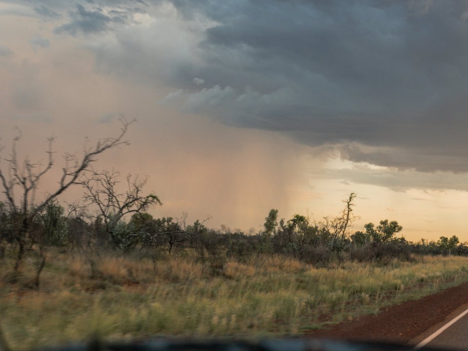Road on a dusty track under a dramatic, cloudy sky in the Top End.
