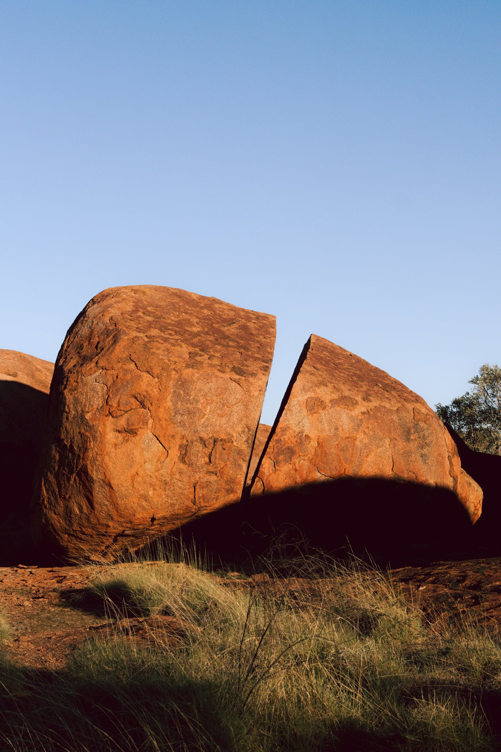 Large orange granite rock formations in a desert landscape.