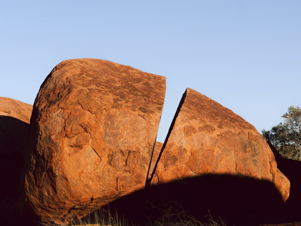 Large orange granite rock formations in a desert landscape.