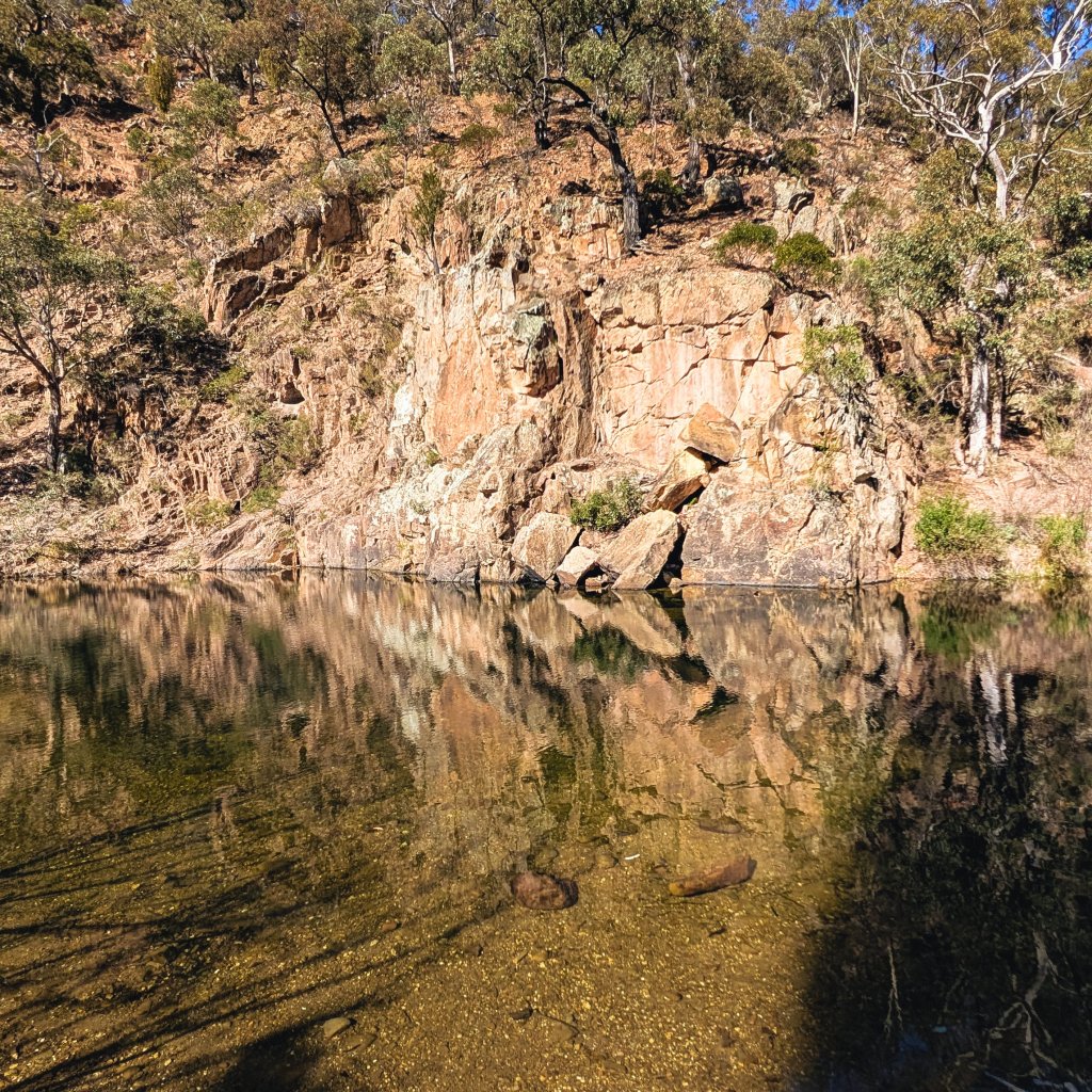 Water reflection over rocky bank in a gorge area.