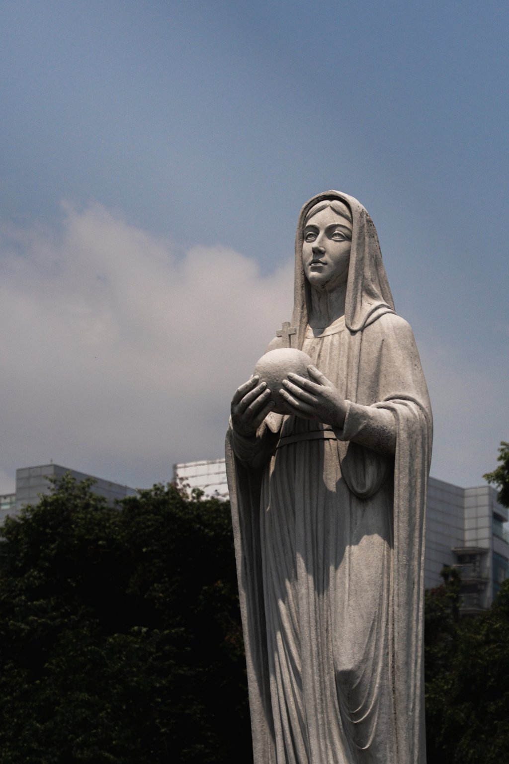 White statue of the Virgin Mary outside Notre Dame Cathedral of Saigon.