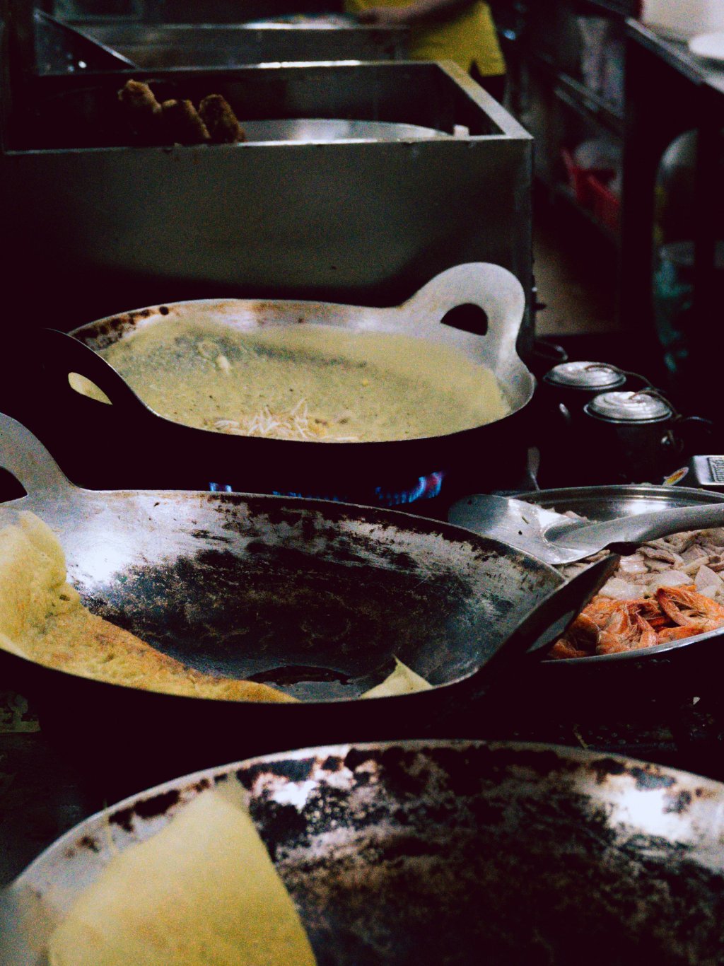 Wok cooking food in a street food setting.