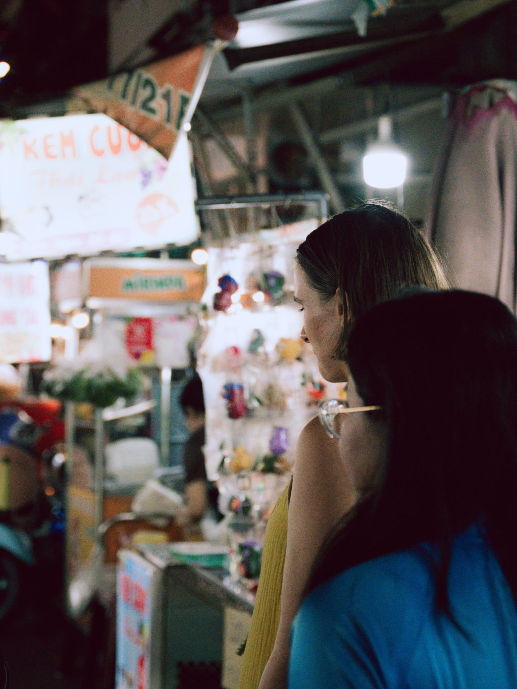 Person looking at items at a market stall in Ho Chi Minh City.