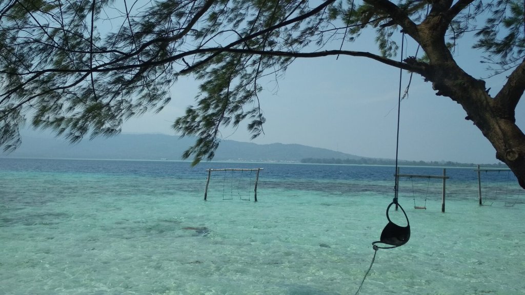 Clear shallow water and sandy coastline at Menjangan Kecil Island in Karimunjawa.