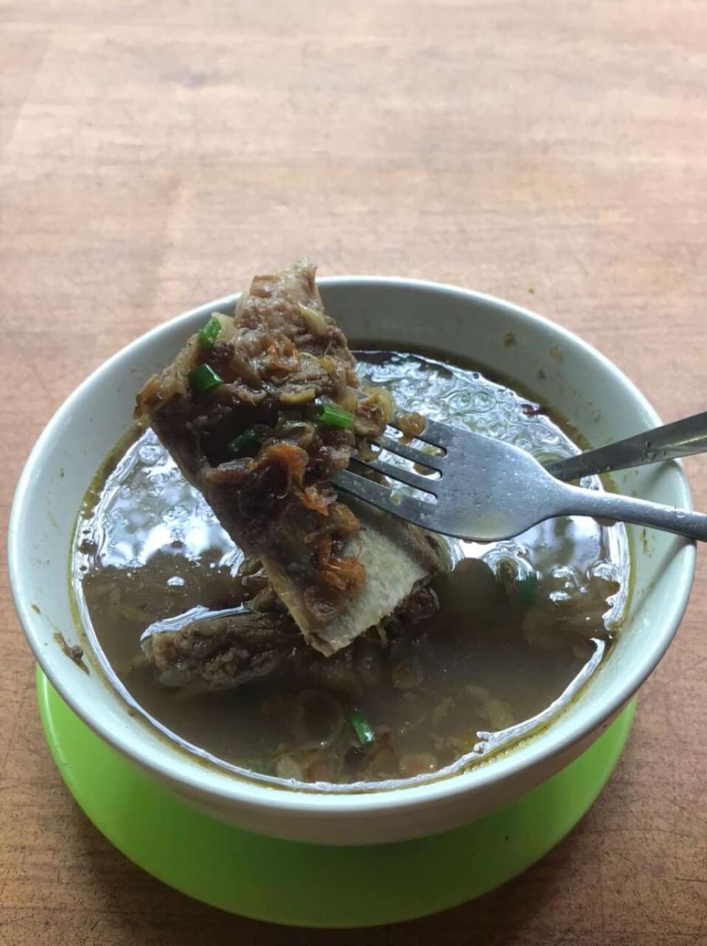 Bebalung Lombok rib soup with meat on the bone in clear broth.