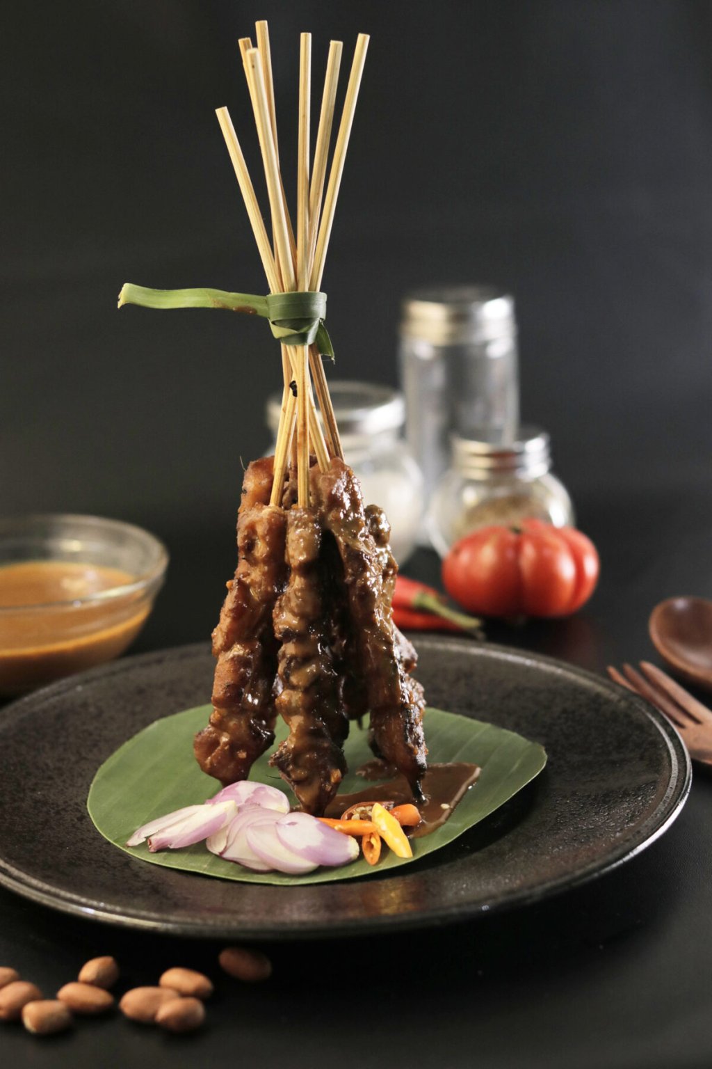 Indonesian fish satay skewers arranged on a plate.